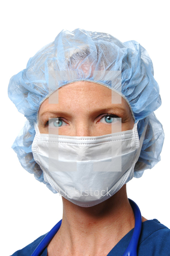 woman surgeon wearing a mask and cap