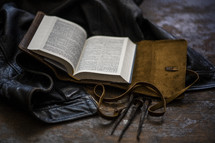 leather jacket, leather-bound Bible, and three nails 