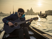 Man with guitar in gondola