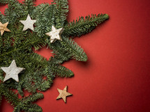 Christmas greenery and stars on a red background 