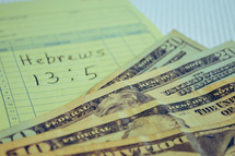 Hebrews 13:5 written on paper and cash 