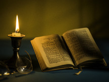 candlestick and open Bible 