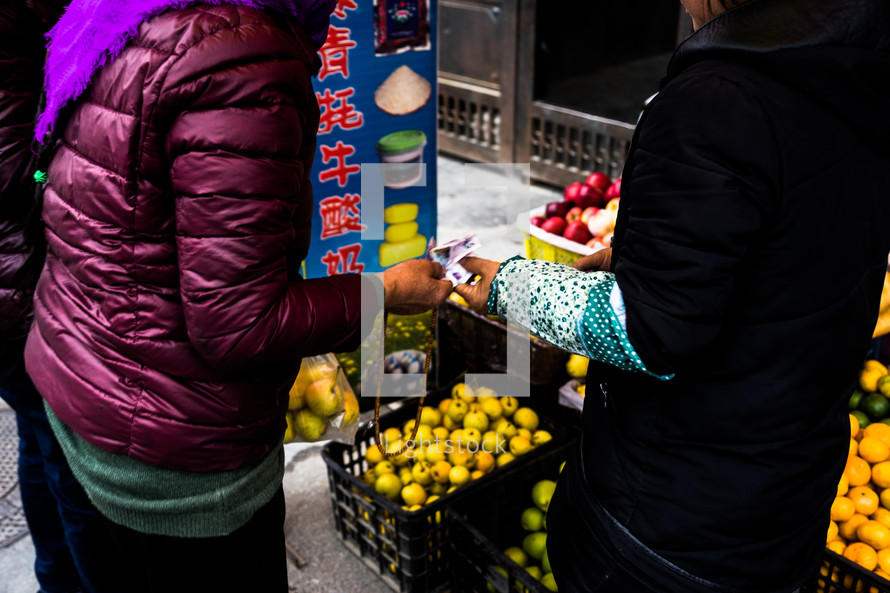 buying produce at a market in China 