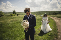 bride and groom in a field 