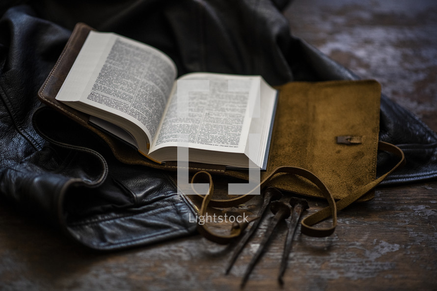 leather jacket, leather-bound Bible, and three nails 