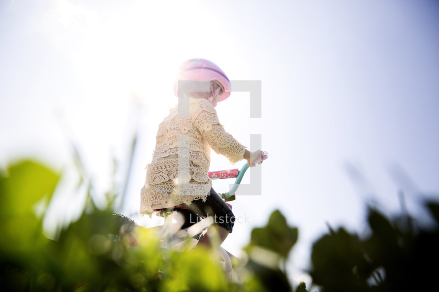 a little girl riding a bicycle 