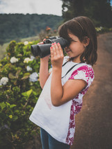 a little girl with a pair of binoculars 