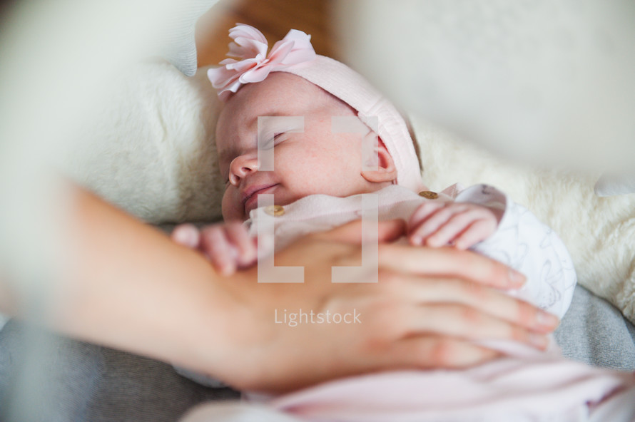 tender hand on a newborn baby 