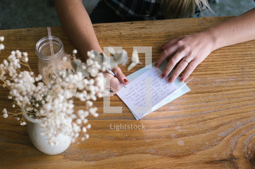 a woman writing a thank you note 