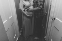 pregnant couple in a hallway 