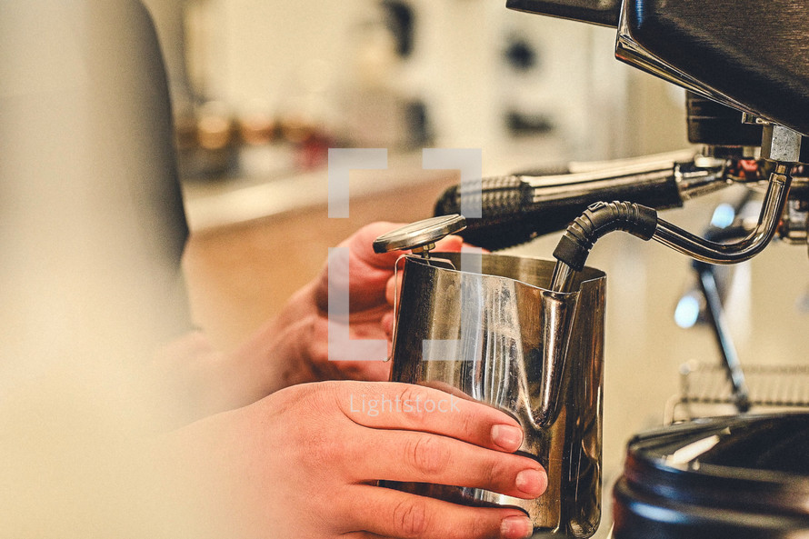 Making coffee latte with espresso machine coffee shop