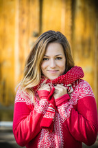 portrait of a young woman bundled up in a red sweater 