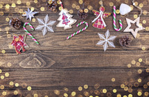 Christmas decorations in a frame on a wooden background with bokeh lights