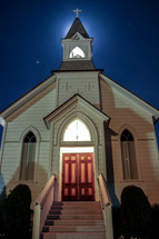white church with steeple at night 