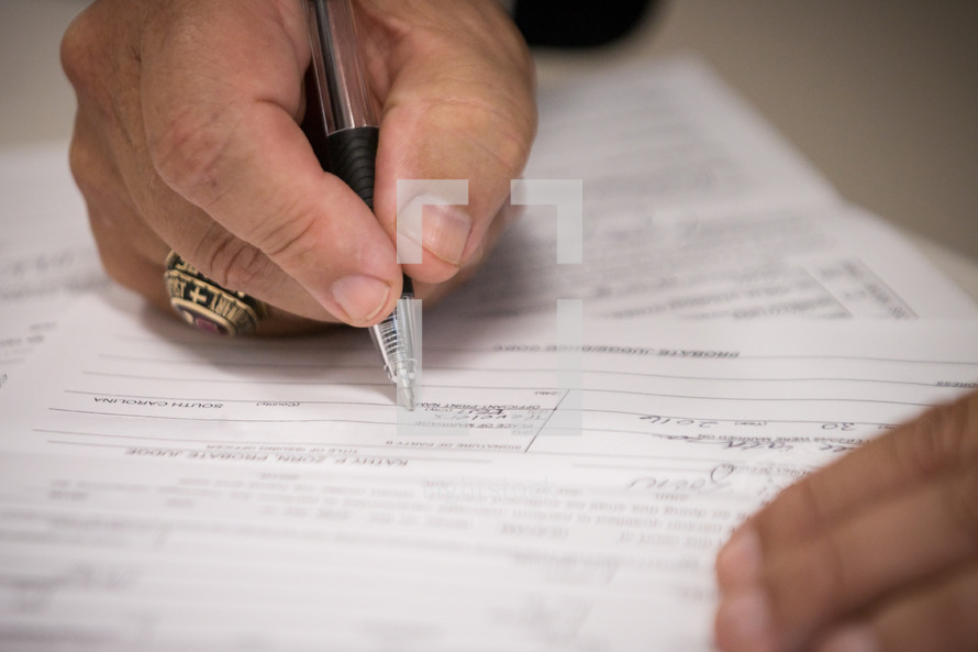 a man signing a document 