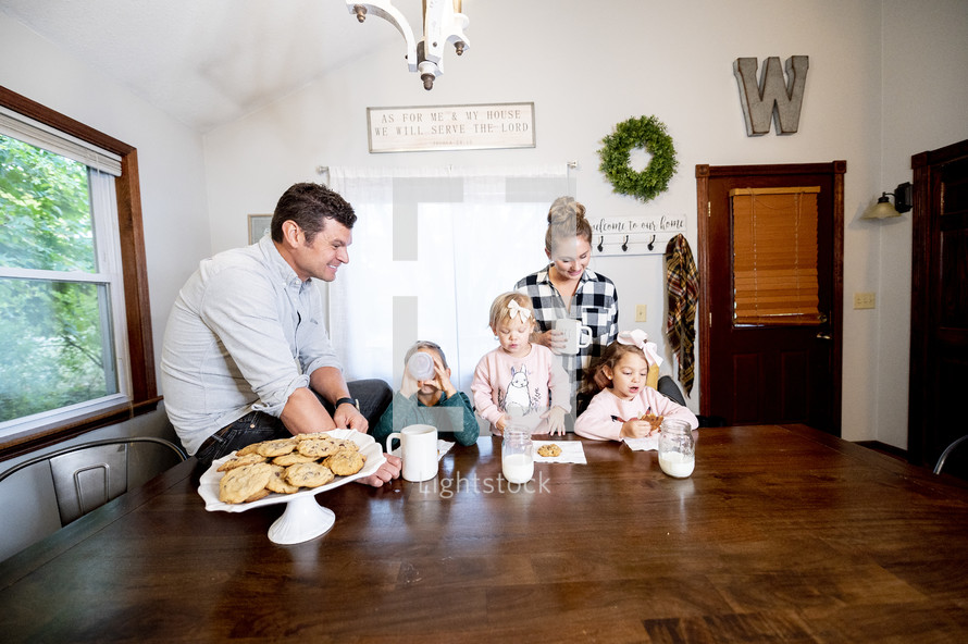 a family having cookies and milk 