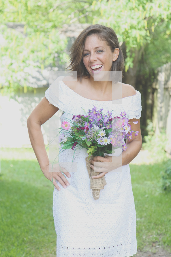 smiling bride holding a bouquet of flowers 
