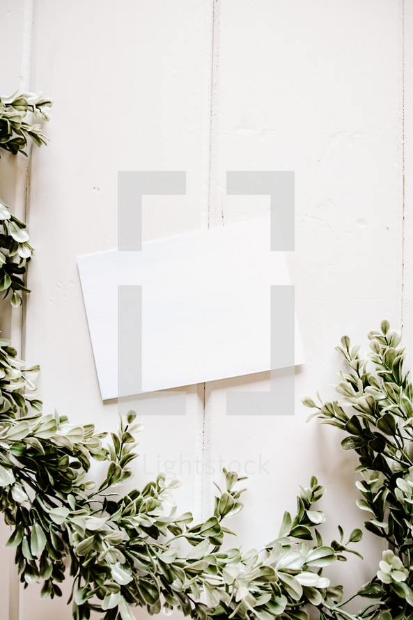 white envelope with boxwood border 