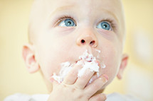 Baby eating whip cream