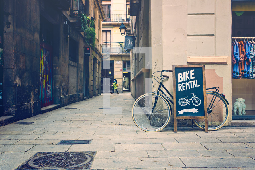 bike rental sign along a sidewalk in Barcelona 