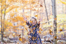 a girl child playing outdoors in fall 