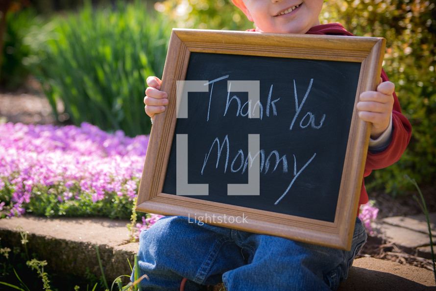 toddler boy holding a chalkboard sign that reads thank you mommy 