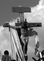 A stark black and white image of Jesus  being crucified on the cross by Roman Soldiers. This is a graphic image but just a glimpse of the suffering that Jesus endured on the cross for our sins and all the sins of mankind. 