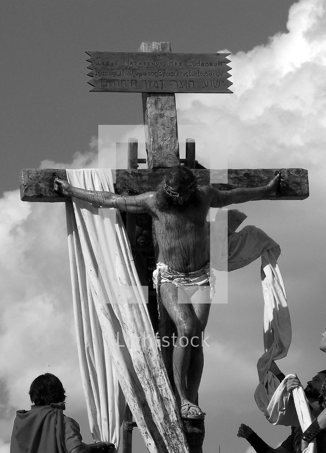 A stark black and white image of Jesus  being crucified on the cross by Roman Soldiers. This is a graphic image but just a glimpse of the suffering that Jesus endured on the cross for our sins and all the sins of mankind. 