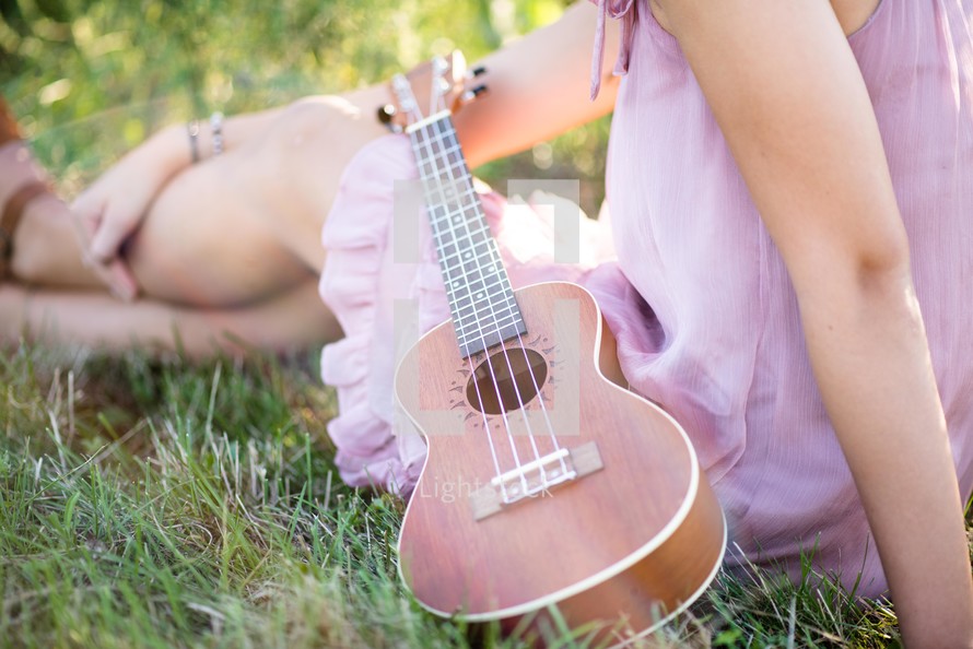 teen girl playing a ukulele 