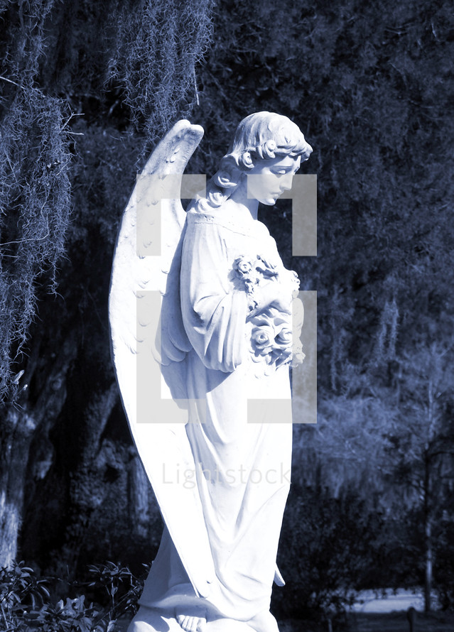 A statue of an angel watches over a grave as if to usher the departed into eternity and keeping watch over them to comfort, encourage and strengthen loved ones grieving over their departed loved one. 