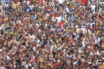 Large crowd worshiping and praising God at a gospel meeting in Africa. Hundreds of thousands, actually the full crowd was in excess of a million, each one a reason why Christ died. 