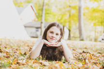 a portrait of a girl in fall leaves 