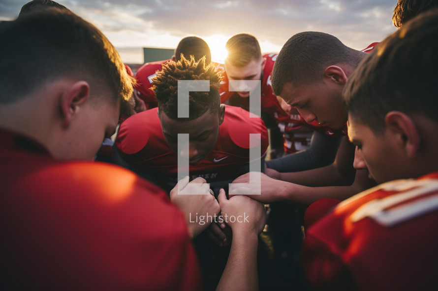 Football team praying before a game
