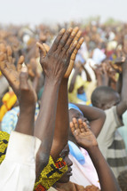 Crowd of Nigerian's lifting their hands in worship