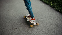 legs of a young woman on a skateboard