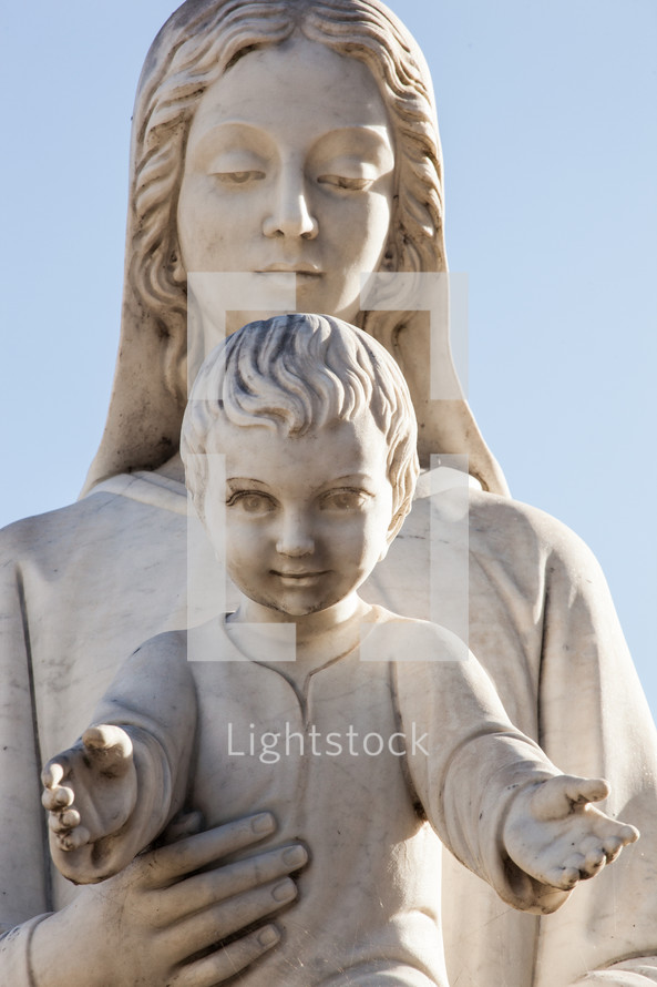 Statue of holy Virgin Mary mother of the child Jesus on blue sky