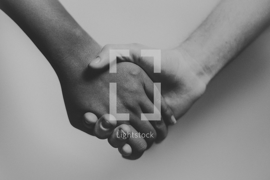 close-up of holding hands against a white background 