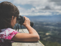 a little girl with binoculars 