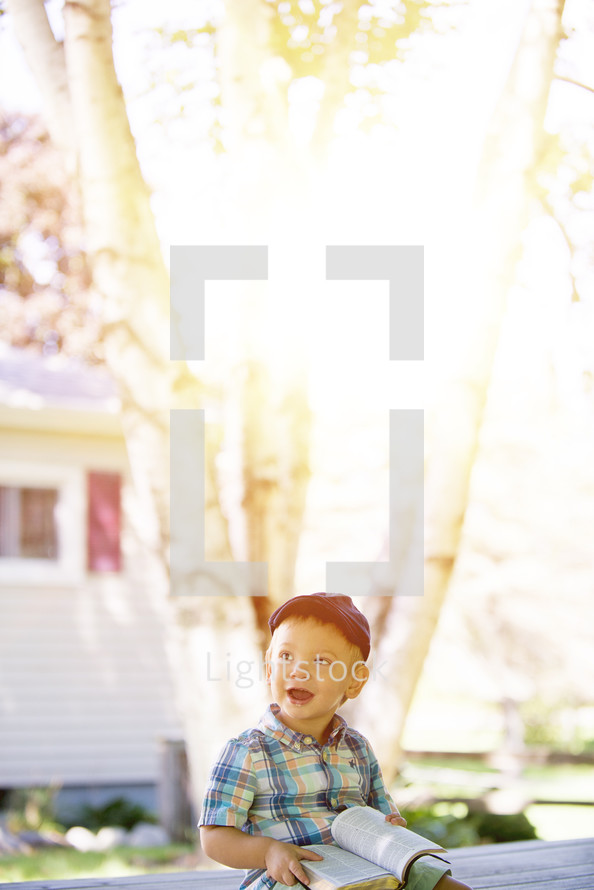 toddler boy with a Bible in his lap 