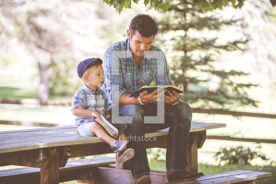 father and son reading a Bible together 