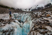 man standing on a glacier 