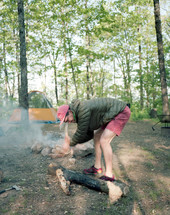 a with an ax chopping up firewood 