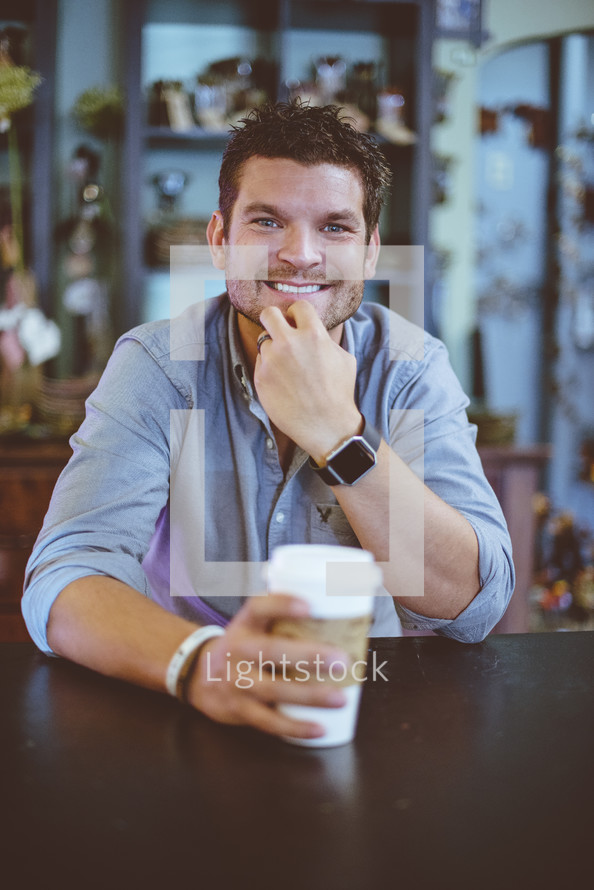 smiling man with a coffee cup 
