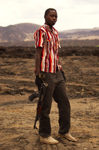 a boy with an AK 47 rifle 