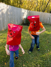 kids being silly with paper bags 
