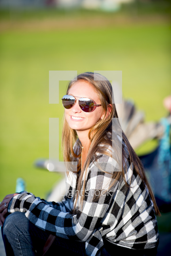 smiling woman watching a sporting event 