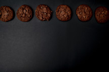 chocolate chocolate chip cookies on a black background 