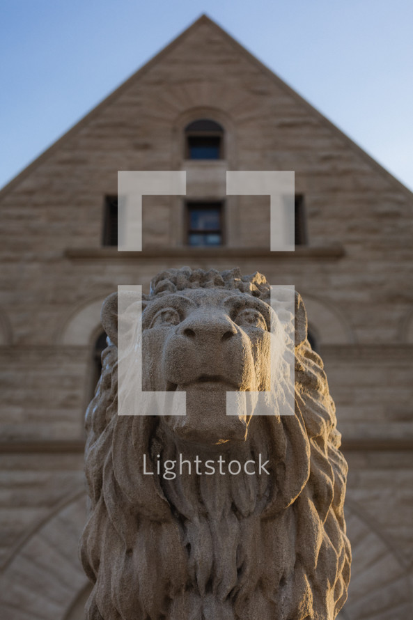 A stone lion in a town square.