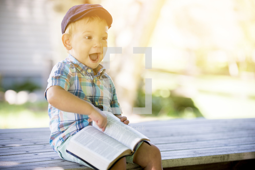 toddler boy with a Bible in his lap 