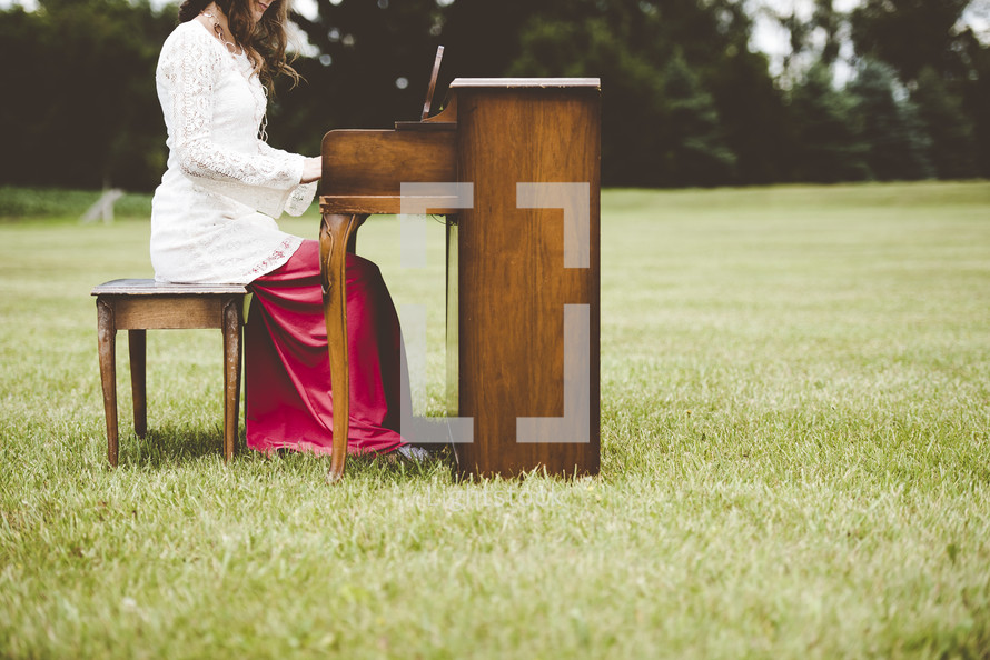 girl playing a piano outdoors 